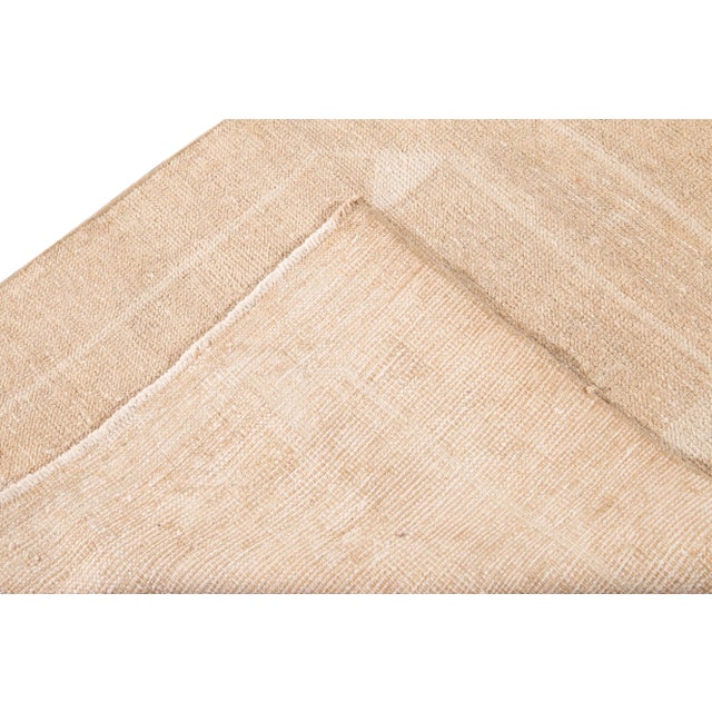 Beautiful vintage Turkish hand-knotted wool runner with a beige field. This rug has ivory accents in an all-over geometric...