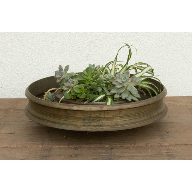 This 21.5-inch Urli is a remarkable found artifact, hand-cast by master metalsmiths in Kerala using the heritage lost-wax...