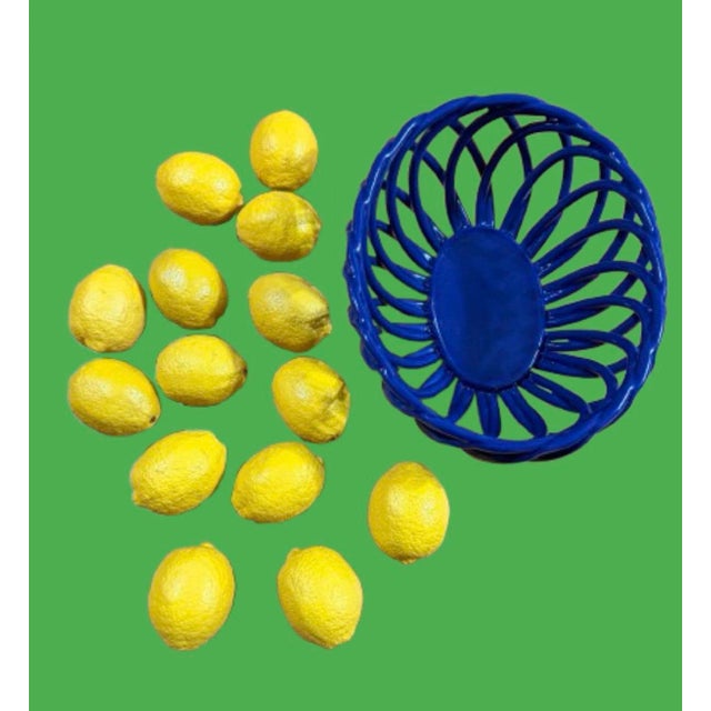 A beautiful vintage blue lattice Italian ceramic oval shaped with open weave basket. Great center piece.