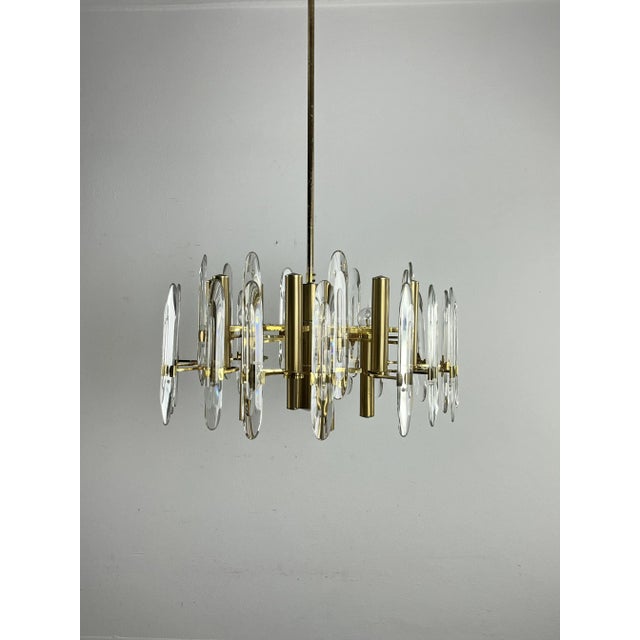 Mid-century Italian Sciolari chandelier with 12 lamp holders and 24 beveled glass prisms radiating from a central tiered...