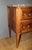 A walnut commode with brass trim, featuring two drawers, a Grey Sainte Anne marble top, a key, and a waxed finish; the...