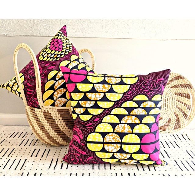 The fuchsia, black, and yellow African print fabric pillow cover is exactly what we recommend to clients who want to...