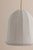 The Risa pendant nods to Neoclassical motifs with its sweeping arches and flutes, yet its materiality is rooted in the...