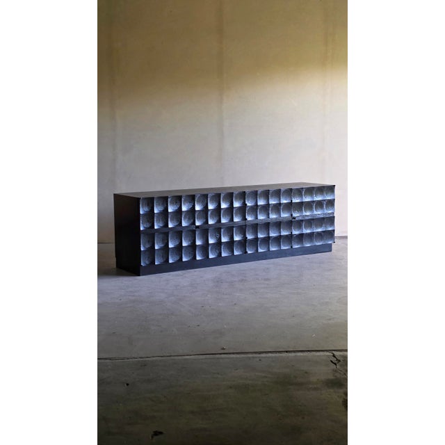Large brutalist sideboard in black ebonized oak produced in the 70s by Mi Belgium and designed by Jean Batenburg. This...