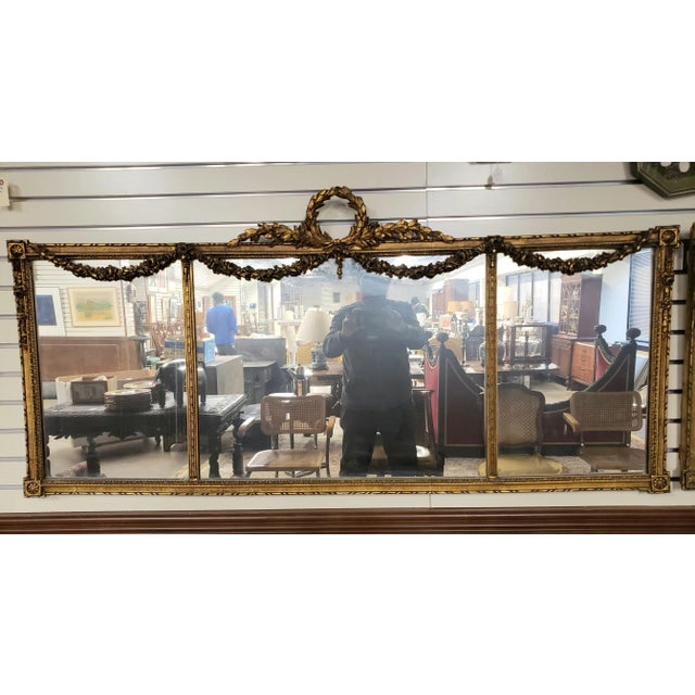 1920s Louis XVI Style Carved Gilt Wood Ornate Three Panel large Over-Mantle Mirror. Two available. Measure 65" in width...