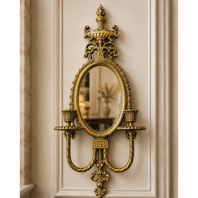Elevate your interior with this exceptional pair of vintage solid brass mirrored wall sconces, masterfully crafted in...