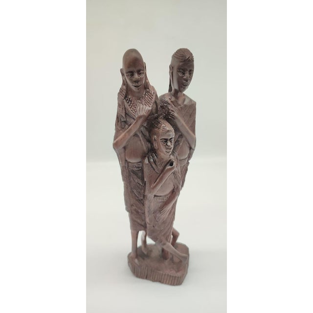 This imposing, 30 cm high sculpture, carved from solid, deep-dark ebony, depicts a three-headed group of figures in the...