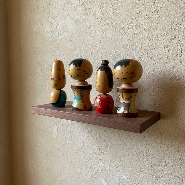 Vintage Japanese miniature kokeshi doll set of four, circa 1960s–1970s. Made in Japan from turned wood with individually...
