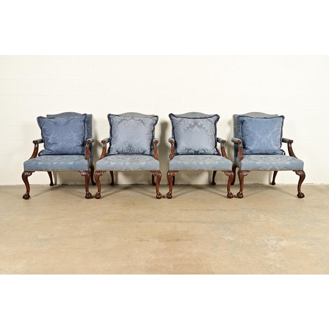 A set of four Chippendale or Georgian carved mahogany open arm library chairs or lounge chairs By Kittinger USA, 1991...