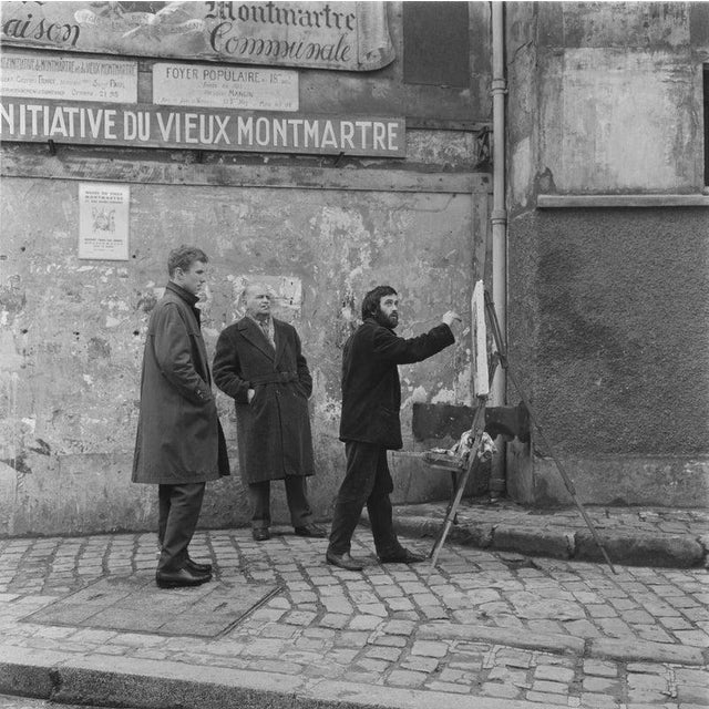 Artist In Montmartre Two men watch an artist at work with an easel in Montmartre, Paris, France, March 1961. (Photo by...