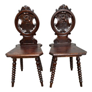 18th Century Italian Chestnut Hall Chairs Carved With Lion Crests - A Pair For Sale