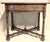 This antique solid oak table appears to be a late 19th or early 20th century (1880-1910) revival side or tavern table, in...