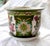 A vintage chinoiserie planter featuring a striking design of peacocks and flowers. This exquisite cachepot boasts a floral...