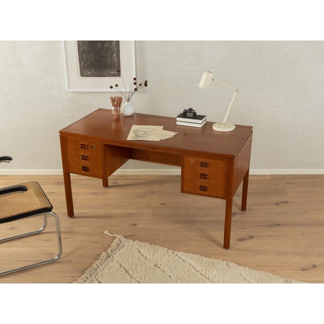 Classic freestanding desk from the 1960s by Tibergaard. High-quality body in teak veneer with six drawers, a book...