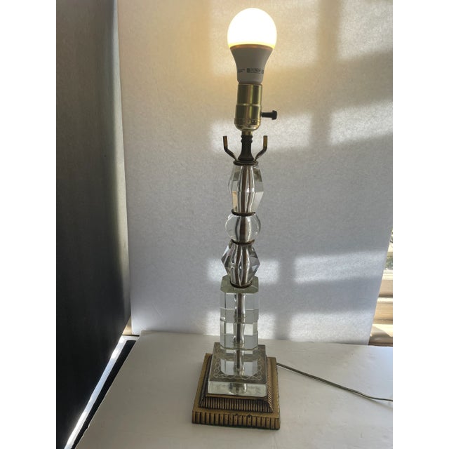 This MCM stunning vintage table lamp is a true piece of art, with a clear glass stacked design and a gilt metal base that...