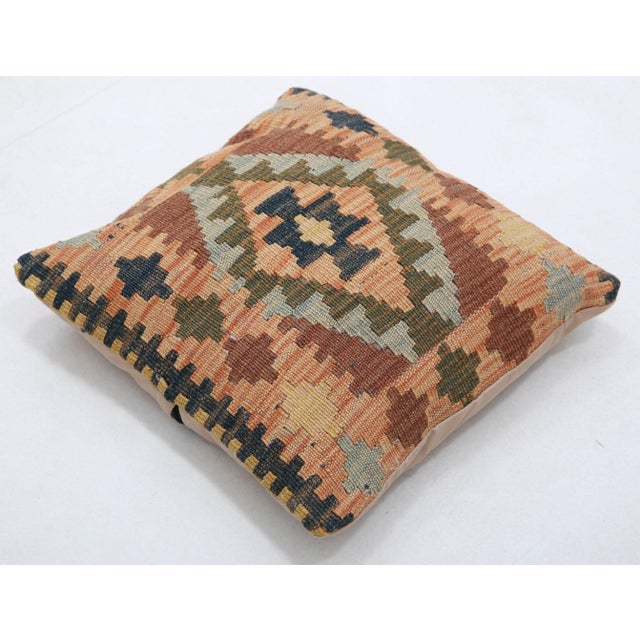 A one-of-a-kind handwoven Afghan wool kilim accent pillow featuring horizontal diamond medallion. Cut and sewn by hand...