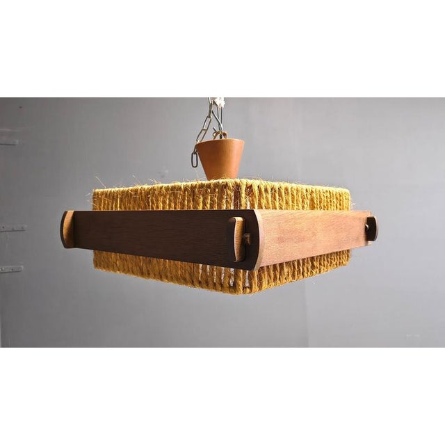Beautiful and rustic pendant light by Temde Switzerland, made from Raffia, wood and acrylic. The fixture uses three E27...
