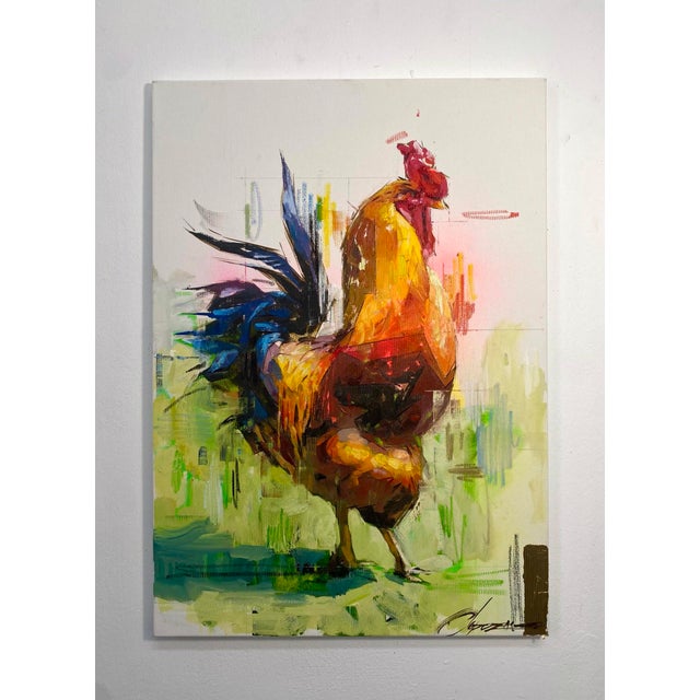 This artwork features a vibrant rooster depicted in bold strokes of acrylic and oil, accentuated by shimmering gold leaf....