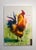 This artwork features a vibrant rooster depicted in bold strokes of acrylic and oil, accentuated by shimmering gold leaf....