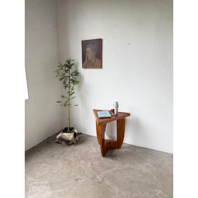 Art Deco console or pedestal table in mahogany and walnut veneer. We love the unique shape of the top, the base with its...