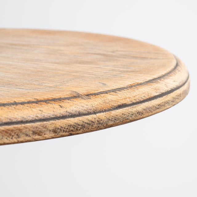 A classic bistro table featuring a cast iron base designed for strength and longevity, paired with a simple top. The form...