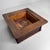 A sober Japanese hibachi made of paulownia wood and copper, with a deep patina, rounded corners and a strong square...