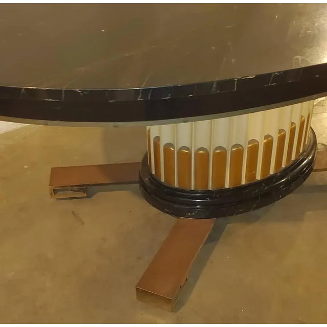 1950s Attributed to Paul Frankl dining table With 2 Leaves and A Fluted Oval Pedestal Base Sitting Above Brass Key Hole...