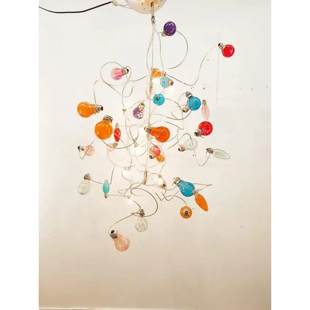 Chandelier with Multiple Colored Bulbs, in Very Good conditions. Designed 1990 to 1999 Up to 250V (Europe/UK Standard).The...
