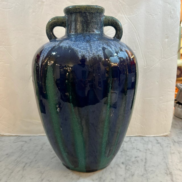 Richly colored deep navy and green drip glaze double handle urn vase. Speckled top portion in green and grey naturally...