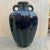 Richly colored deep navy and green drip glaze double handle urn vase. Speckled top portion in green and grey naturally...