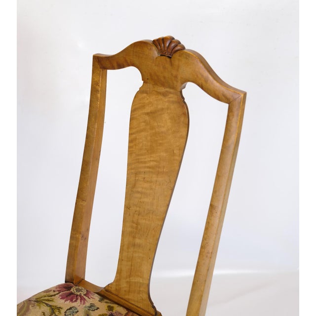 Antique dining room chairs in light mahogany with light fabric upholstery made in rococo style from around the 1920s....