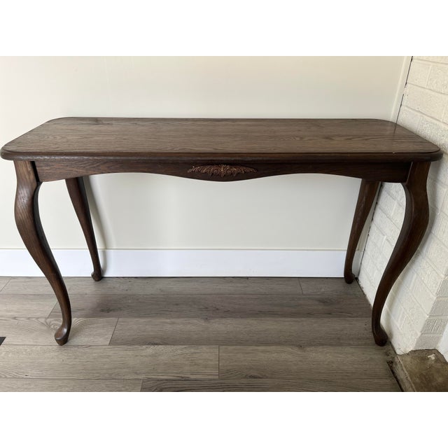 This is a solid oak carved out “sofa table” that was likely hand carved around the 1940’s and is styled after the very...