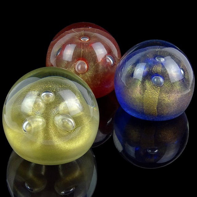 Beautiful vintage Murano hand blown red, blue and gold Italian art glass paperweights with bubble decoration. Sold as a...