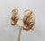 1950s goldtone ribbed raised leaf with curled stem and round raised circle at the bottom clip earrings. Marked "NAPIER...