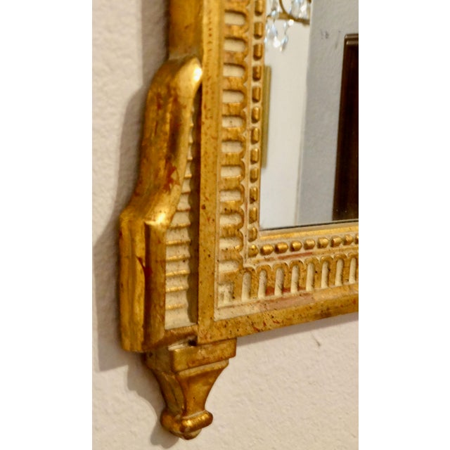 French Louis XV Style gilt wood and gesso wall mirror. It features a rectangular shape with a gilt wood frame, decorative...