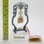 This vintage silver decorative object depicts an asian chinese ritual bell mounted on a custom acrylic glass display...