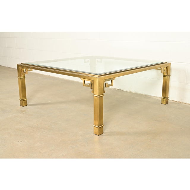 An exceptional mid-century modern Hollywood Regency coffee table or cocktail table By Mastercraft USA, 1970s Brass frame...