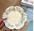 Employing underglaze painting techniques, the plate features a petal-shaped rim and is decorated with delicate blue and...