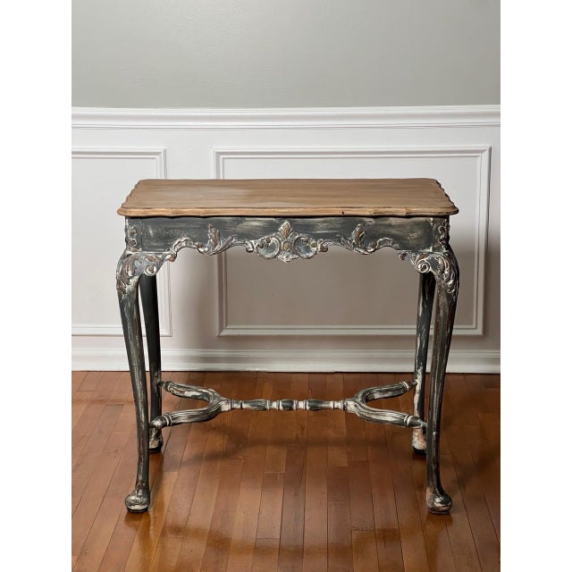 French Louis XV style painted table with a distressed finish, late 19th century. A painted, faux natural finish tabletop...