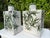 A striking pair of antique hand-painted pottery vessels featuring olive branch decoration on a richly crazed ivory...