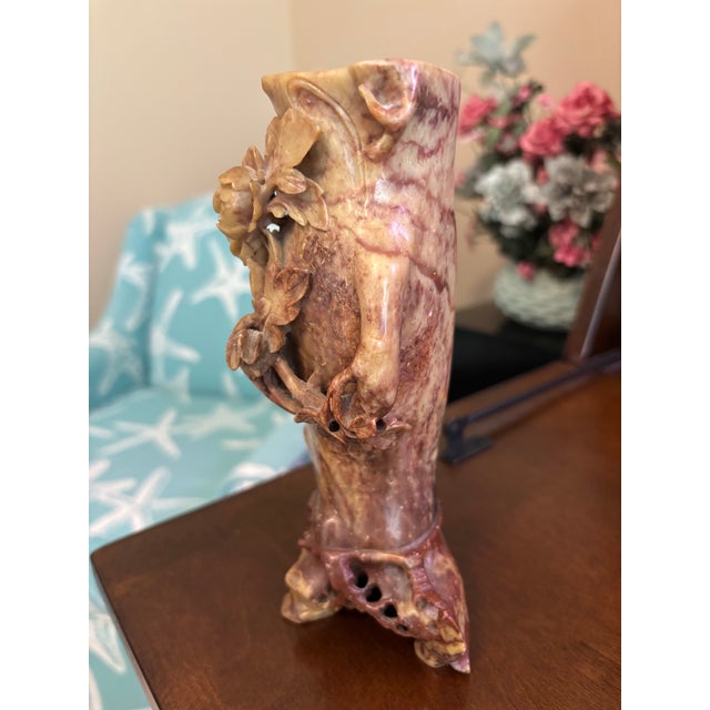 A striking antique Chinese hand-carved soapstone vase featuring deeply sculpted floral and foliate motifs in high relief....
