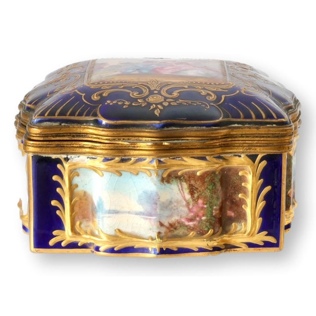 An exquisite late nineteenth century French porcelain box in the Sèvres taste, richly decorated with hand-painted...