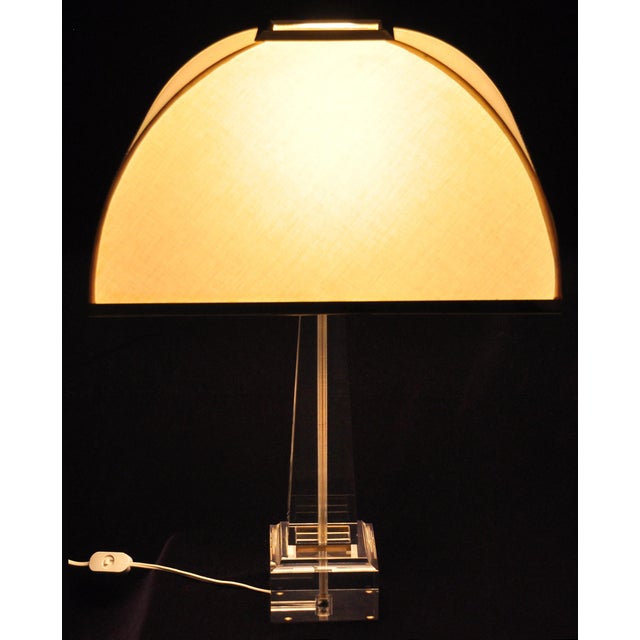 Stunning obelisk-form lucite table lamp with gold-plated brass details, designed by Romeo Rega for Les Arcades. Circa...