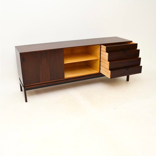 A beautiful and very rare Danish vintage sideboard by Hans Hove and Palle Petersen. This was made in Denmark in the...