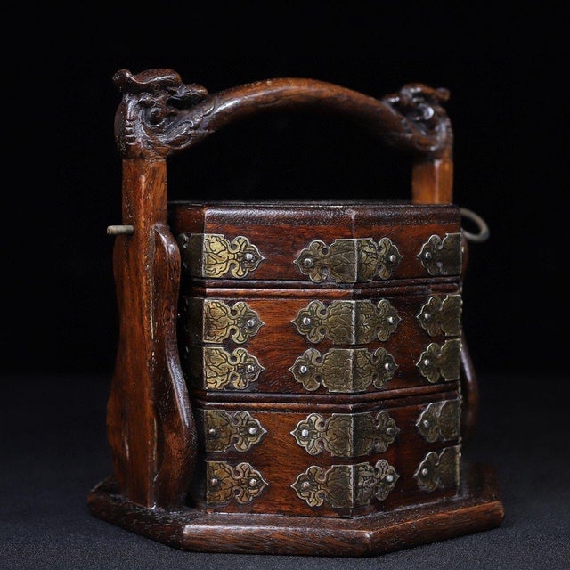 A stunning vintage Chinese tiered carrying box (Tihe) carved from Huali (rosewood) featuring a rich, warm patina. This...