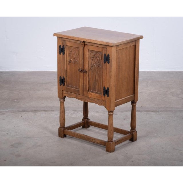 Charming Danish oak cabinet from the 1960s, featuring a distinctive brutalist design with numerous beautiful details. Its...