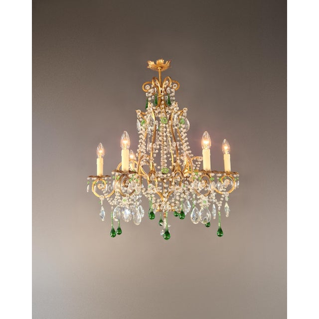 This decorative crystal chandelier in the Italian Rococo style captivates with its flowing lines, floral details, and...