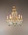 This decorative crystal chandelier in the Italian Rococo style captivates with its flowing lines, floral details, and...