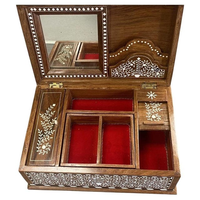 A beautifully crafted Indian jewellery box, handmade from high-quality rosewood and extensively decorated with...