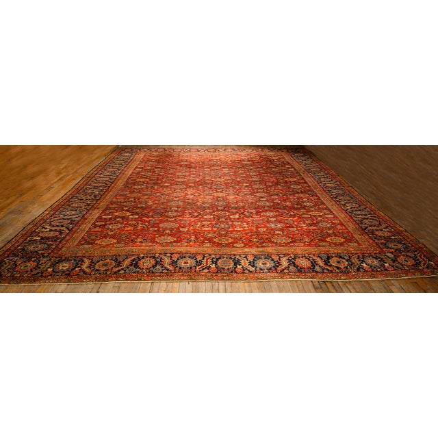 A monumental palace-sized Antique Persian Sultanabad carpet, circa 1890. Measuring an expansive 15' x 16' 2", this rare...